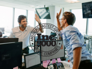 Two men giving each other high-fives in an office