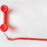 Red phone on a white backdrop