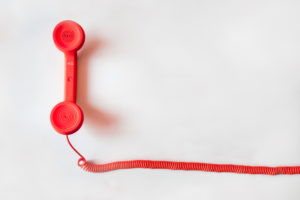 Red phone on a white backdrop