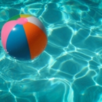 Beach ball in clear, blue water