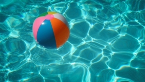 Beach ball in clear, blue water